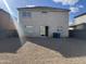 Exterior rear of the home with a door leading to a zero-scaped backyard at 6819 S 38Th Dr, Phoenix, AZ 85041