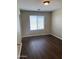 Bedroom with wood-look floors, neutral walls and natural light coming from the window at 6819 S 38Th Dr, Phoenix, AZ 85041