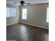 Bedroom featuring wood-look floors, neutral walls, a ceiling fan and windows with blinds at 6819 S 38Th Dr, Phoenix, AZ 85041