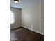 Bedroom with wood-look floors, neutral paint and natural light from the bright window at 6819 S 38Th Dr, Phoenix, AZ 85041