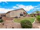 Beautifully landscaped backyard featuring a cozy covered patio and vibrant greenery, perfect for relaxing and entertaining at 700 W Gascon Rd, San Tan Valley, AZ 85143