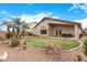 Expansive backyard with lush green grass, desert landscaping, and a covered patio, perfect for Gathering gatherings at 700 W Gascon Rd, San Tan Valley, AZ 85143