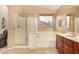 Bathroom featuring a separate tub and glass shower, with cherry wood vanity and neutral tones at 700 W Gascon Rd, San Tan Valley, AZ 85143