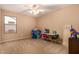 Bright, carpeted bedroom with neutral tones and a ceiling fan at 700 W Gascon Rd, San Tan Valley, AZ 85143