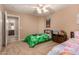 Bright bedroom with neutral colors, ceiling fan and two beds; one with a Minecraft themed comforter at 700 W Gascon Rd, San Tan Valley, AZ 85143