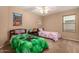 bedroom featuring two beds, a ceiling fan and a large window at 700 W Gascon Rd, San Tan Valley, AZ 85143