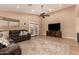 Inviting living room featuring a comfortable leather sofa, ceiling fan, and backyard access at 700 W Gascon Rd, San Tan Valley, AZ 85143