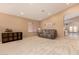 Cozy living room featuring plush seating, carpeted floors, and ample natural light at 700 W Gascon Rd, San Tan Valley, AZ 85143