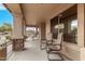 Inviting covered porch with stone accents, offering a relaxing outdoor seating area at 700 W Gascon Rd, San Tan Valley, AZ 85143