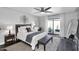 Cozy bedroom with a neutral color palette, ceiling fan, and access to an outdoor patio at 718 E Tuckey Ln, Phoenix, AZ 85014