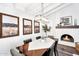 Inviting dining room featuring a modern light fixture, fireplace, and stylish decor at 718 E Tuckey Ln, Phoenix, AZ 85014