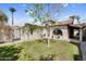 The backyard features desert landscaping, a grassy area, and a stucco wall at 718 E Tuckey Ln, Phoenix, AZ 85014