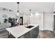 Stylish kitchen island with stainless steel appliances, quartz countertops, and pendant lighting at 718 E Tuckey Ln, Phoenix, AZ 85014