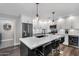 Beautiful kitchen with white cabinets, subway tile backsplash, and a large center island with bar seating at 718 E Tuckey Ln, Phoenix, AZ 85014