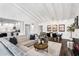 Bright and airy living area features vaulted ceilings, modern furnishings, and a seamless flow to the kitchen at 718 E Tuckey Ln, Phoenix, AZ 85014