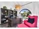 Home office with a large window, desk, bookshelf, and accent chair at 718 E Tuckey Ln, Phoenix, AZ 85014