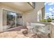 Cozy patio space with elegant white patio furniture and a glimpse of the surrounding greenery at 7436 E Chaparral Rd # B103, Scottsdale, AZ 85250