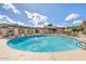 Beautiful community pool area with clear blue water, lounge chairs, and well-kept surroundings at 7436 E Chaparral Rd # B103, Scottsdale, AZ 85250