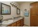 Double sink bathroom, with two mirrors, neutral colors, and wooden cabinets at 8651 E Royal Palm Rd # 206, Scottsdale, AZ 85258