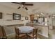 Cozy dining area with adjacent kitchen, and a ceiling fan, and decorative shelving at 8651 E Royal Palm Rd # 206, Scottsdale, AZ 85258