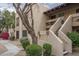 Beautifully landscaped condo complex with charming architectural details and mature desert vegetation at 8651 E Royal Palm Rd # 206, Scottsdale, AZ 85258