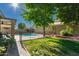 Backyard with lush green grass and a sparkling swimming pool; a great place to relax at 9212 W Salter Dr, Peoria, AZ 85382