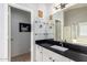 Bathroom featuring a black countertop, framed mirror and open doorway to toilet room at 9212 W Salter Dr, Peoria, AZ 85382