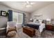 Cozy bedroom with carpet, ceiling fan, and a large window with shutters at 9212 W Salter Dr, Peoria, AZ 85382