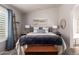 Comfortable bedroom with neutral colors, a ceiling fan, and a large window with shutters at 9212 W Salter Dr, Peoria, AZ 85382