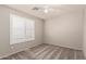 This is a bedroom with gray walls and gray carpet plus a window with white shutters at 9212 W Salter Dr, Peoria, AZ 85382