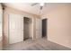 This is a bedroom with beige walls and gray carpet plus a closet and doorway at 9212 W Salter Dr, Peoria, AZ 85382