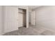 This bedroom has neutral colored walls, carpet, and an open closet with sliding doors at 9212 W Salter Dr, Peoria, AZ 85382