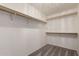 A view of a walk-in closet with white walls and shelving at 9212 W Salter Dr, Peoria, AZ 85382