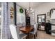 Elegant dining room featuring a chandelier, a large mirror, and seating for six at 9212 W Salter Dr, Peoria, AZ 85382