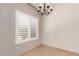 Bright dining space featuring a classic chandelier and modern window shutters at 9212 W Salter Dr, Peoria, AZ 85382