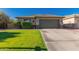 Charming single-story home with a well-manicured lawn and a spacious two-car garage at 9212 W Salter Dr, Peoria, AZ 85382