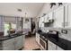 Bright kitchen with granite countertops, white cabinets, and an eat-in dining area at 9212 W Salter Dr, Peoria, AZ 85382