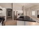 Well-lit kitchen with stainless steel appliances and an island with a black countertop at 9212 W Salter Dr, Peoria, AZ 85382