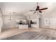Spacious open-concept living area with tile floors and a modern kitchen at 9212 W Salter Dr, Peoria, AZ 85382