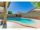 This backyard features a large swimming pool surrounded by block fencing at 9212 W Salter Dr, Peoria, AZ 85382