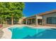 Inviting backyard pool with cool, clear water and a large tree providing shade at 9212 W Salter Dr, Peoria, AZ 85382