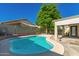 Beautiful swimming pool with seating area surrounded by green grass and patio at 9212 W Salter Dr, Peoria, AZ 85382