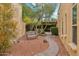 Serene backyard garden featuring a winding stone path, mature trees, and a cozy seating area for relaxation and tranquility at 9445 N 106Th St, Scottsdale, AZ 85258