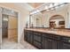 Bathroom featuring double sinks with granite countertops and a large mirror at 9445 N 106Th St, Scottsdale, AZ 85258