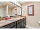 Well-lit bathroom featuring a granite countertop vanity, framed mirror, and neutral decor creating a clean and functional space at 9445 N 106Th St, Scottsdale, AZ 85258