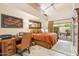 Bright bedroom with high ceilings, a work desk, and a sliding door to a cozy patio area at 9445 N 106Th St, Scottsdale, AZ 85258