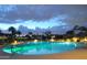 Night view of the luxurious, brightly lit community pool at 9445 N 106Th St, Scottsdale, AZ 85258