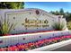 Elaborate welcome sign for Mercado at Scottsdale Ranch, surrounded by flower beds at 9445 N 106Th St, Scottsdale, AZ 85258