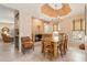 Dining room area with a fireplace, chandelier, and natural lighting at 9445 N 106Th St, Scottsdale, AZ 85258