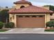 Attached garage with a secure and stylish door enhances the home's curb appeal and provides convenient parking at 9445 N 106Th St, Scottsdale, AZ 85258